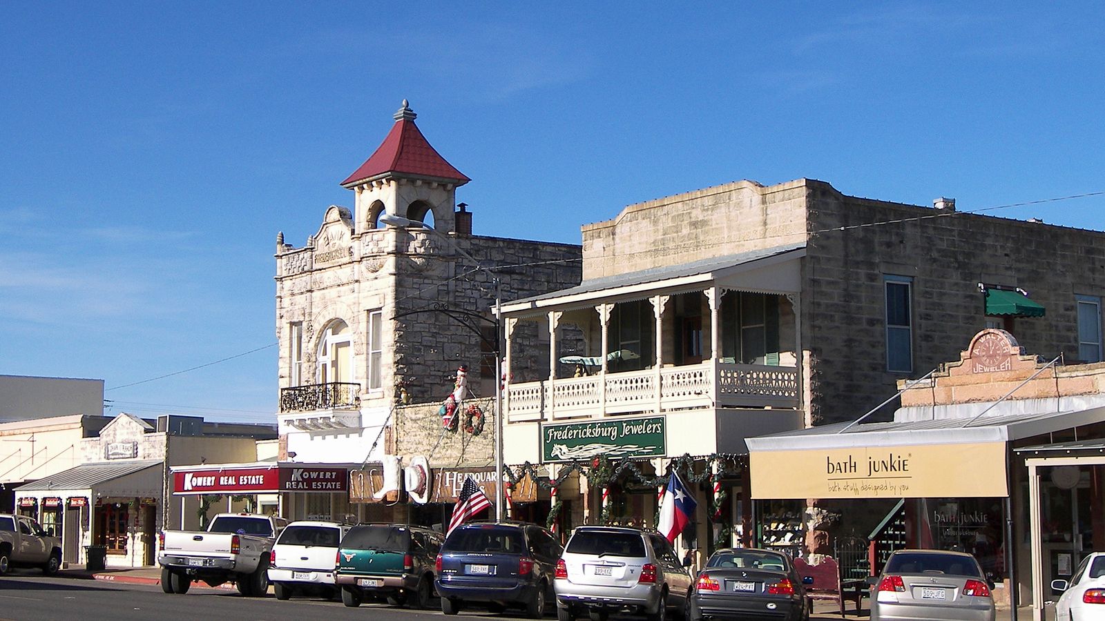 Limestone storefronts on East Main Street in Fredericksburg, with the Old Fredericksburg Bank's red tower.