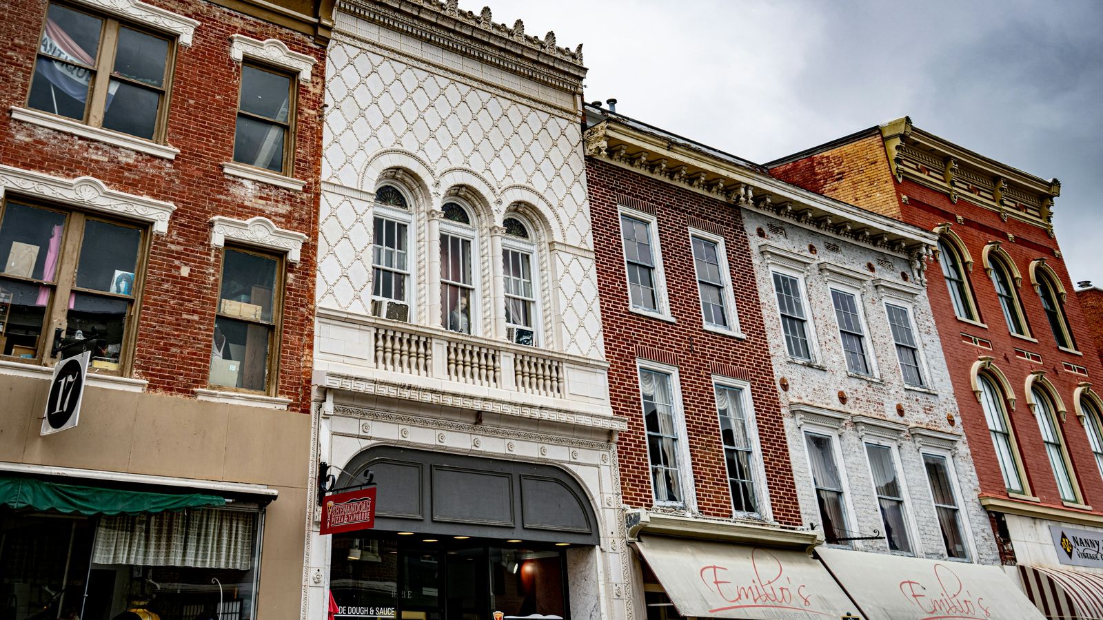 Ornate Victorian storefronts in brick, white and red on a downtown Staunton street.